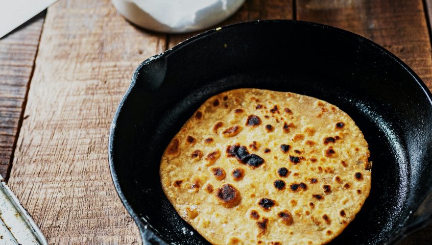 Naan bread in a frying pan